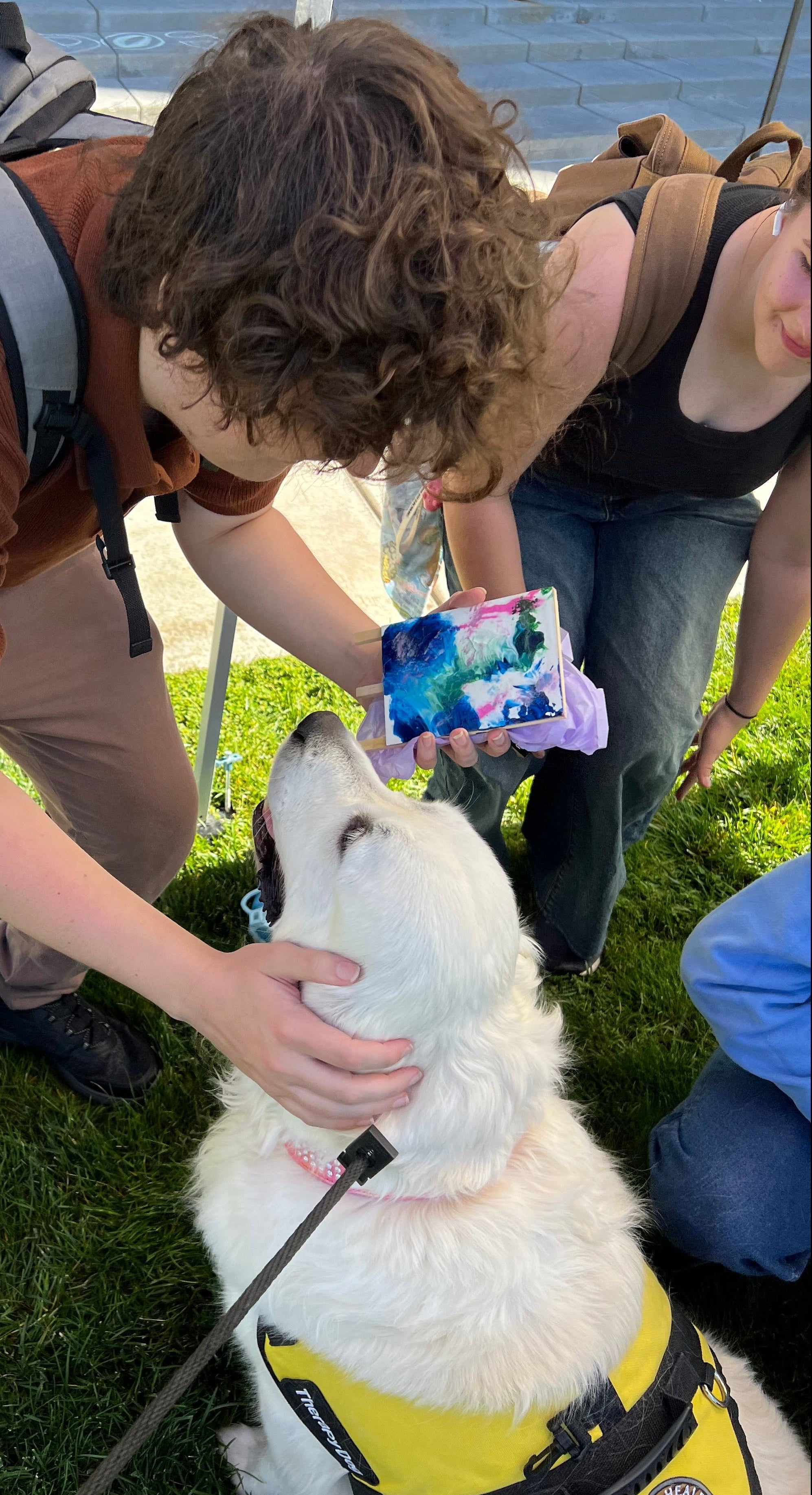 Biscuit_on_a_mission_giving_a_UVU_student_art_she_painted.